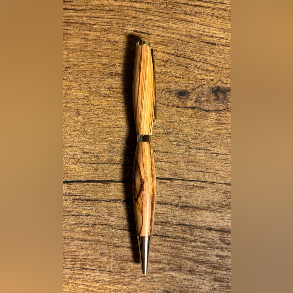 Beautiful hand turned wood ink pen. Smooth writing black ink. Gold accents.
